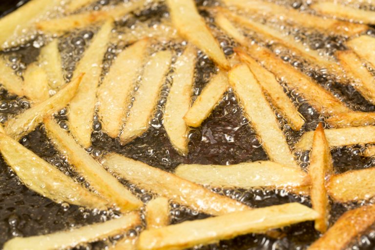 French fries cooking in hot frying oil